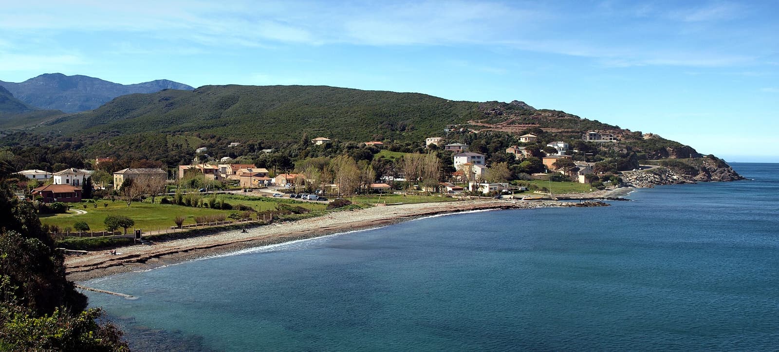 The curving beach and green hills of the marine of Sisco on the east coast of Cap Corse