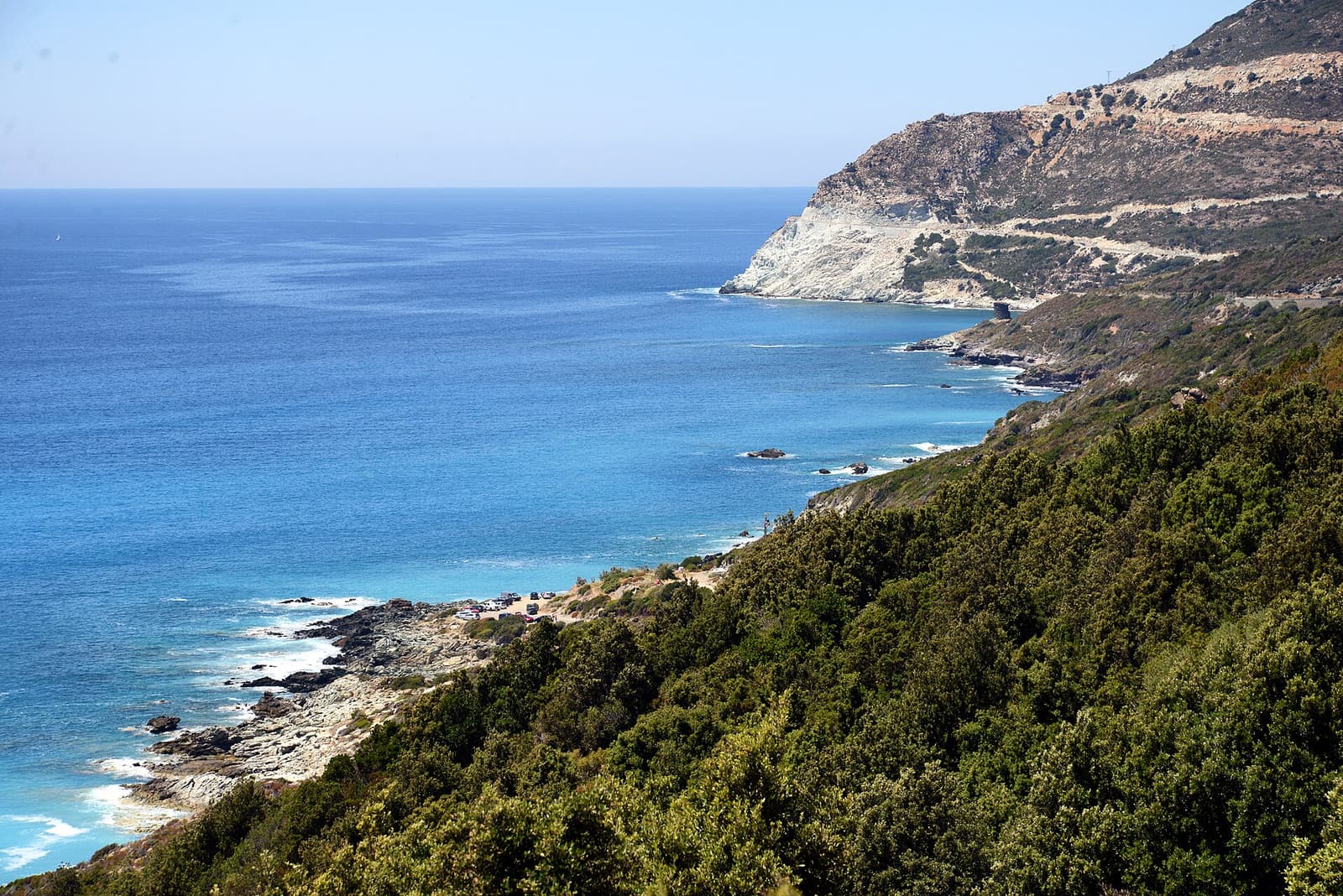 The west coast of Cap Corse north of Nonza, with pale cliffs dropping into a bright blue sea