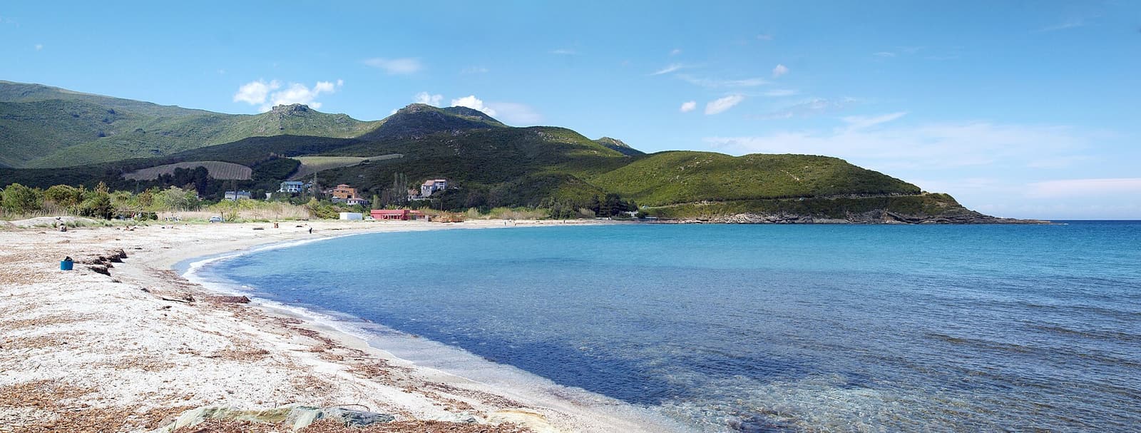 The sandy beach of Pietracorbara and clear shallow water on a sunny day
